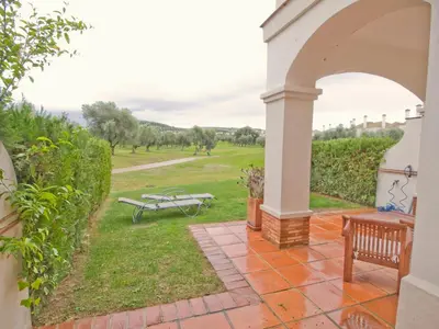 a patio with a bench and a picnic table at Villa 210 by Villamya in Arcos de la Frontera