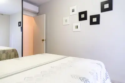 a bedroom with a bed with pictures on the wall at El Caletero by Gades Gestión in Cádiz