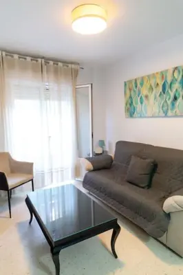 a living room with a couch and a coffee table at El Caletero by Gades Gestión in Cádiz