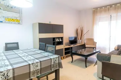 a room with a bed and a desk and a couch at El Caletero by Gades Gestión in Cádiz