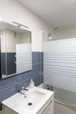 a bathroom with a sink and a mirror at El Caletero by Gades Gestión in Cádiz