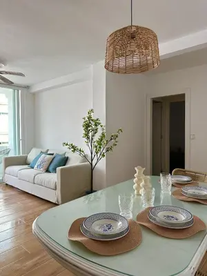 a living room with a table with plates on it at Casita de la playa en Durango in El Puerto de Santa María