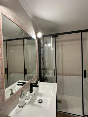 a bathroom with a white sink and a shower at Casita de la playa en Durango in El Puerto de Santa María