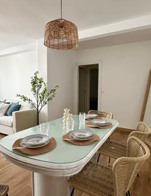 a dining room with a table and chairs at Casita de la playa en Durango in El Puerto de Santa María
