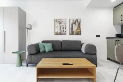 a living room with a couch and a coffee table at Limehome Jerez de la Frontera Marqués de Casa-Domecq in Jerez de la Frontera