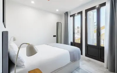 a white bedroom with a bed and a window at Limehome Jerez de la Frontera Marqués de Casa-Domecq in Jerez de la Frontera