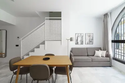 a living room with a table and a couch at Limehome Jerez de la Frontera Marqués de Casa-Domecq in Jerez de la Frontera