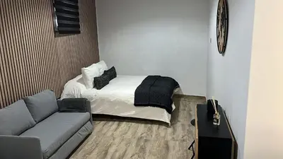 a small room with a bed and a couch at Apartamento Empedrado in Jerez de la Frontera