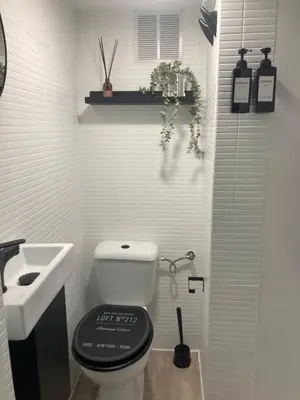 a white bathroom with a toilet and a sink at Apartamento Empedrado in Jerez de la Frontera