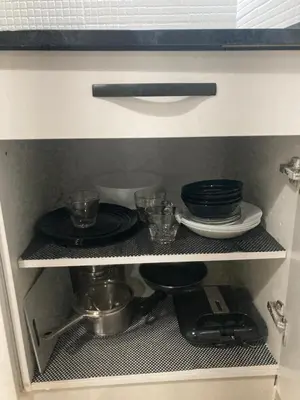 a kitchen cabinet with plates and dishes on a shelf at Apartamento Empedrado in Jerez de la Frontera