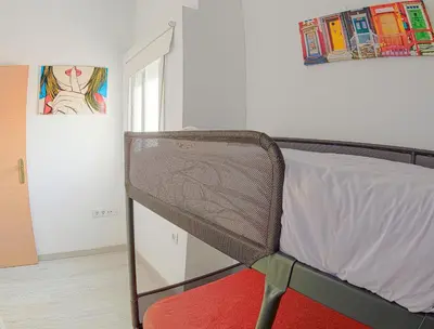 a bedroom with a bed and a chair in it at CDZ - Carmen Coronada in Cádiz