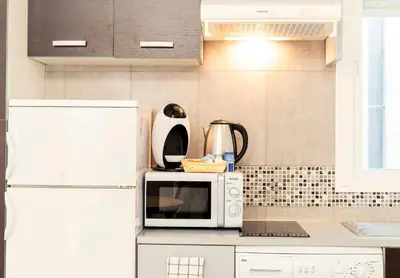 a kitchen with a white refrigerator and a microwave at CDZ - Carmen Coronada in Cádiz