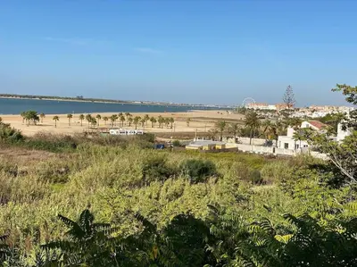 a view of a beach and a body of water at Apartamento Di Matteo, Playa-Piscina in Sanlúcar de Barrameda