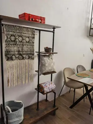 a shelf in a room with a table and chairs at La casa vertical in Cádiz