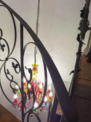 a christmas ornament hanging from a metal fence at La casa vertical in Cádiz