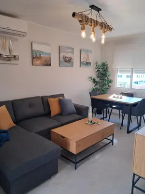 a living room with a couch and a table at PLAYA PASEO MARITIMo in Sanlúcar de Barrameda