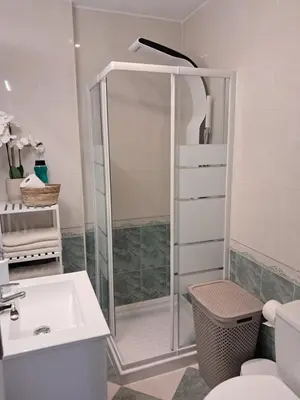 a bathroom with a shower and a toilet and a sink at PLAYA PASEO MARITIMo in Sanlúcar de Barrameda