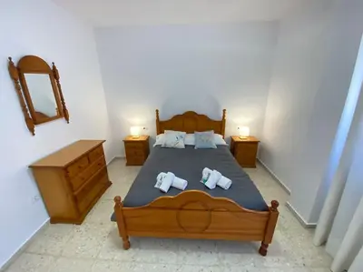a bedroom with a bed with two pillows on it at Apartamento Parque Bolsa in Sanlúcar de Barrameda