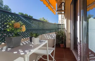 a balcony with a table and potted plants on it at Amplio y Luminoso 3 Rooms Parking in Jerez de la Frontera