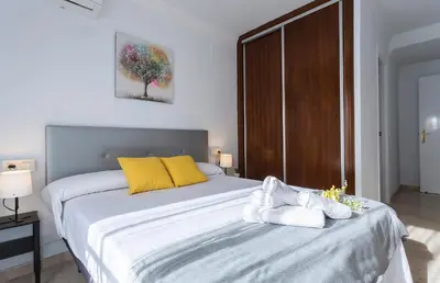 a bedroom with a large bed with towels on it at Amplio y Luminoso 3 Rooms Parking in Jerez de la Frontera