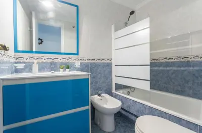 a blue and white bathroom with a toilet and a sink at Amplio y Luminoso 3 Rooms Parking in Jerez de la Frontera