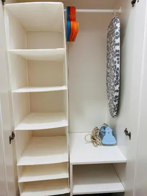 a closet with white shelves and a tie at Estudio Casa Palacio 2Pax wifi gratis in Sanlúcar de Barrameda