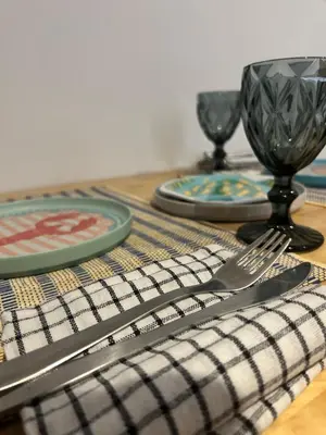 a table with two plates and a fork and knife at Estudio Casa Palacio 2Pax wifi gratis in Sanlúcar de Barrameda