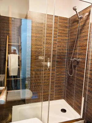a bathroom with a shower with a glass door at Estudio Casa Palacio 2Pax wifi gratis in Sanlúcar de Barrameda