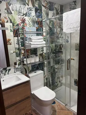 a bathroom with a toilet and a sink and a shower at Villa jiguera in Cádiz