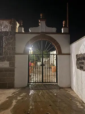 an entrance to a building with a gate at night at Villa jiguera in Cádiz