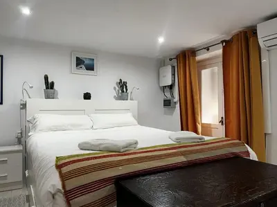 a bedroom with a white bed and a window at Little Cadiz Grupo AC Gestion in Cádiz