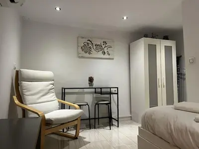 a bedroom with a bed and a chair and a table at Little Cadiz Grupo AC Gestion in Cádiz