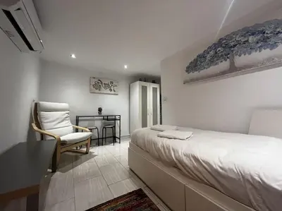 a bedroom with a bed and a table and a chair at Little Cadiz Grupo AC Gestion in Cádiz