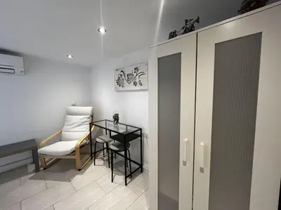 a room with a table and a chair and a table and a cabinet at Little Cadiz Grupo AC Gestion in Cádiz