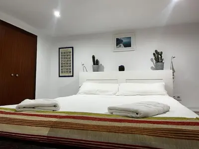 a bedroom with a white bed with two pillows on it at Little Cadiz Grupo AC Gestion in Cádiz