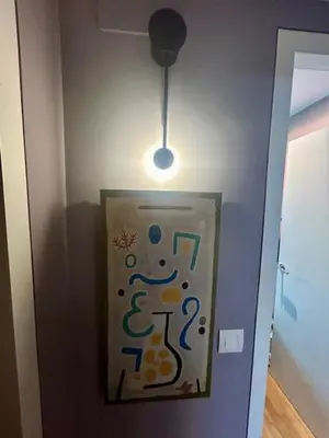 a sign on a wall in a room with a light at GATU Exótica , 