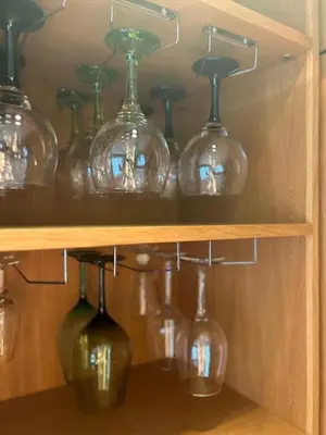 a bunch of wine glasses on a shelf at GATU Exótica , 