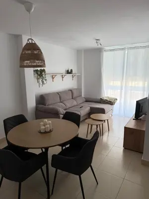 a living room with a couch and a table and chairs at Piso completo en Chiclana de la Frontera in Chiclana de la Frontera