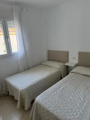 a bedroom with two beds and a window at Piso completo en Chiclana de la Frontera in Chiclana de la Frontera