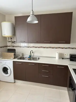 a kitchen with a sink and a washing machine at Piso completo en Chiclana de la Frontera in Chiclana de la Frontera