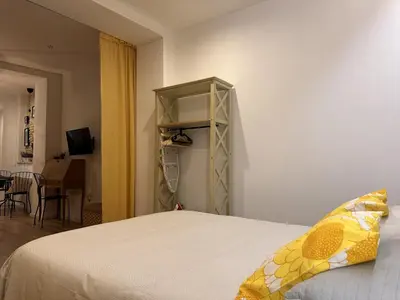 a bedroom with a bed and a small closet at Apartamento Santa Clara - Ole Solutions in Jerez de la Frontera