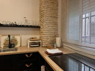 a kitchen with a counter with a sink and a stone wall at Apartamento Santa Clara - Ole Solutions in Jerez de la Frontera
