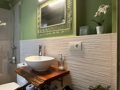 a bathroom with a bowl sink and a mirror at Apartamento Santa Clara - Ole Solutions in Jerez de la Frontera