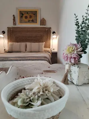 a bedroom with a bed and a bowl of flowers on a table at Patio & Sherry Apartamento in Jerez de la Frontera