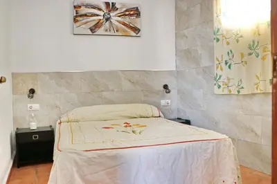 a bedroom with a bed in a room at Chalet Mendoza in Conil de la Frontera