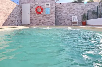 a large pool of water with a chair in it at Chalet Mendoza in Conil de la Frontera