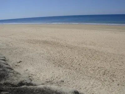 an empty beach with the ocean in the background at Life Apartments Costa Ballena in Costa Ballena
