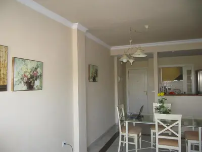 a dining room and kitchen with a table and chairs at Life Apartments Costa Ballena in Costa Ballena