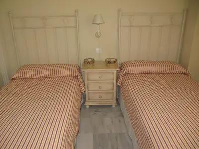 two beds sitting next to a night stand in a room at Life Apartments Costa Ballena in Costa Ballena