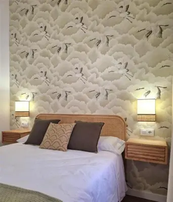 a bedroom with a bed and a wall with clouds at AGR Apartamento Villapanés in Jerez de la Frontera